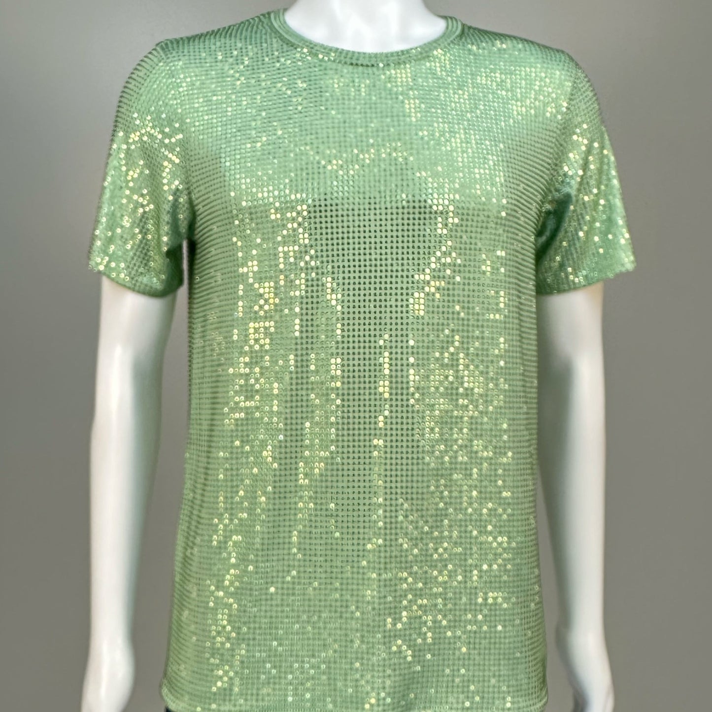 Blurred view of Lt. Green Crystals on Lt. green Fabric T-shirt demonstrating how the garment sparkles in videos.