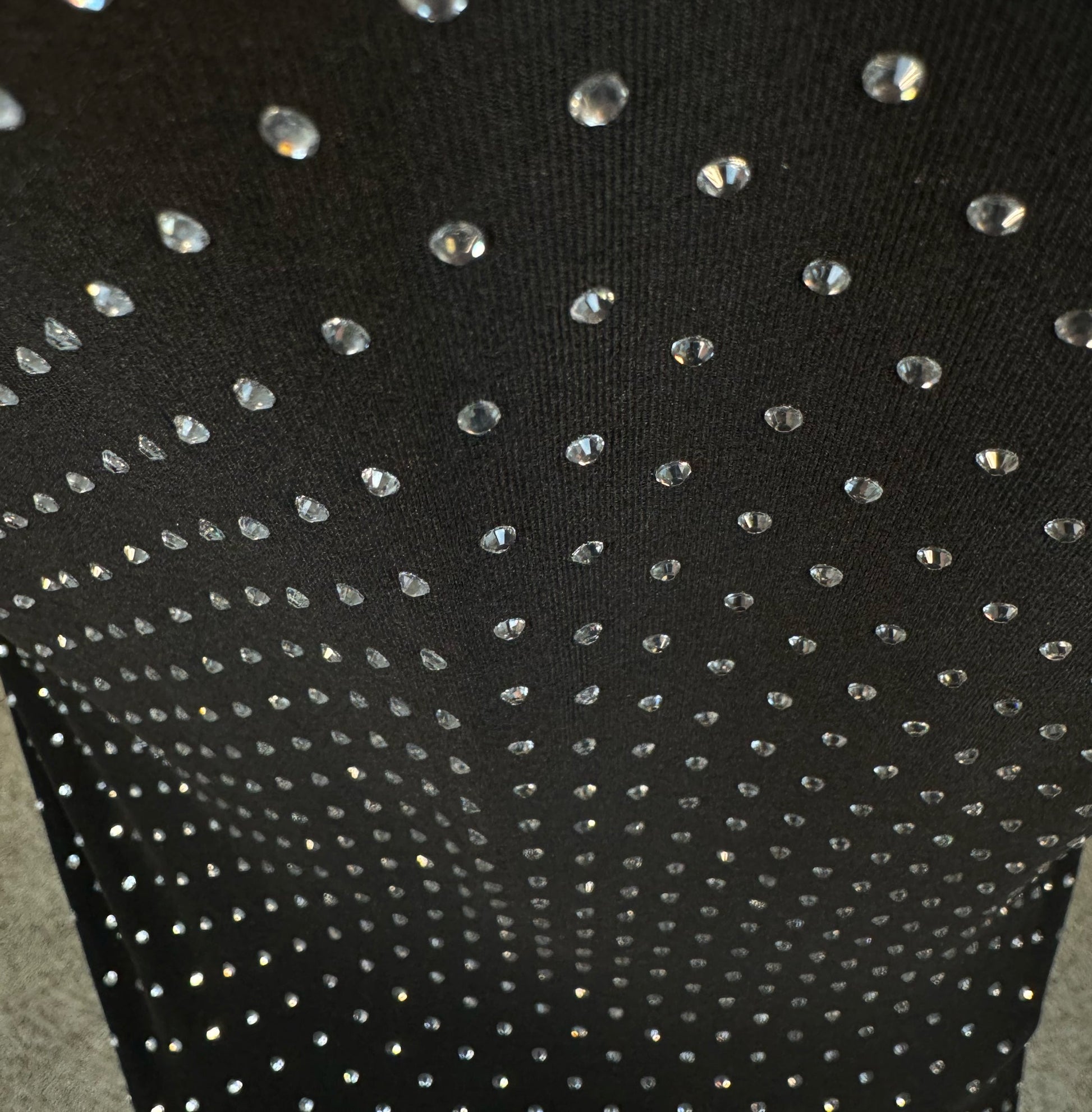 Looking down at Clear Crystals on Black Fabric Dotted T-shirt showing a close up of the rhinestone grid pattern and the sparkles as your focus shifts.