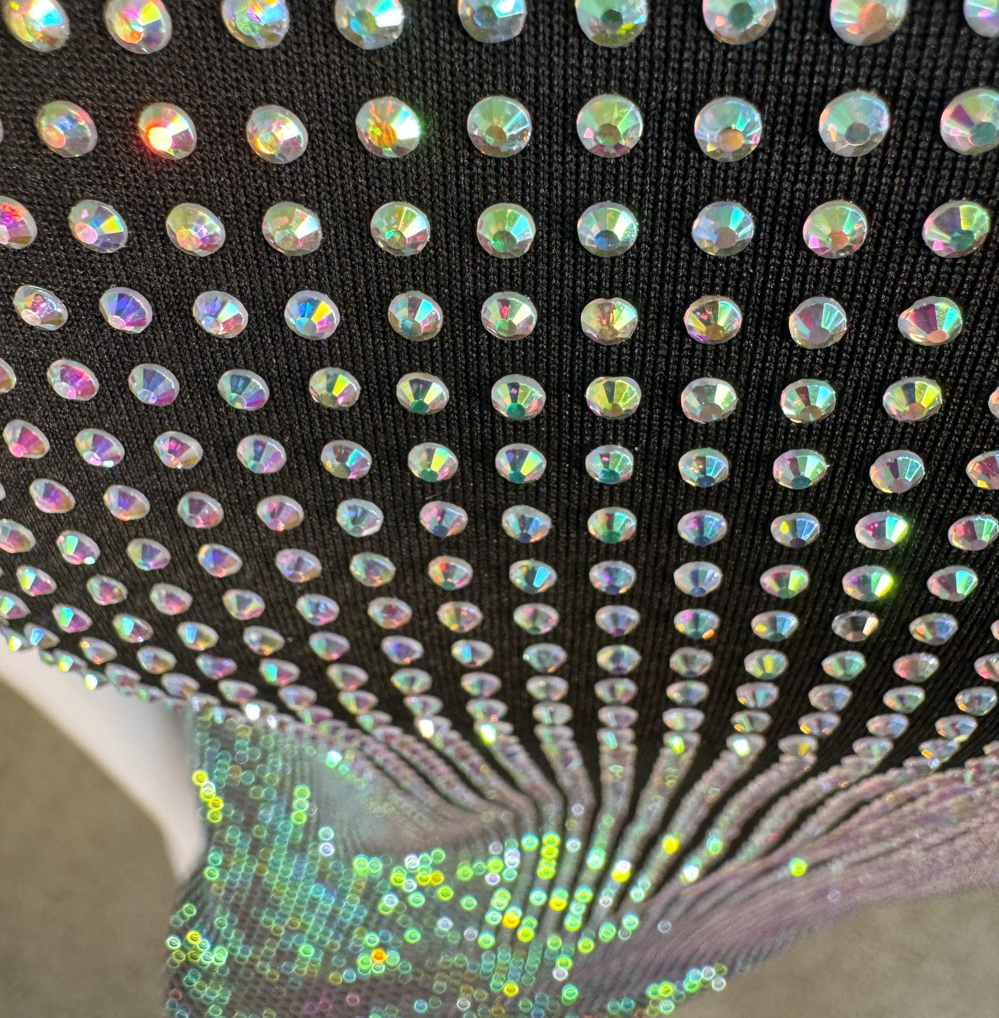 Looking down at Clear AB Crystals on Black Fabric T-shirt showing a close up of the rhinestone grid pattern and the sparkles as your focus shifts.