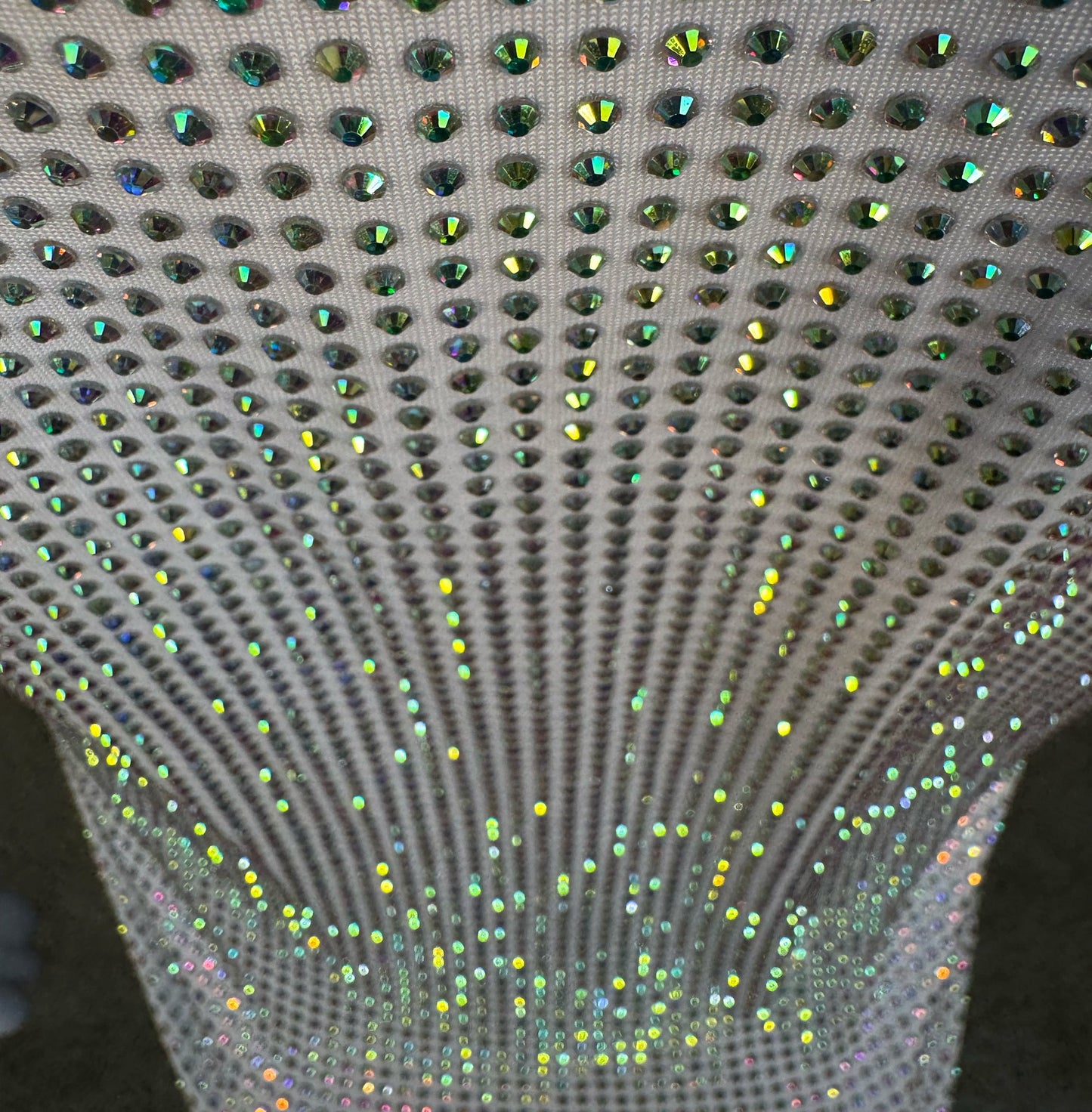 Looking down at Clear AB Crystals on White Fabric T-shirt showing a close up of the rhinestone grid pattern and the sparkles as your focus shifts.