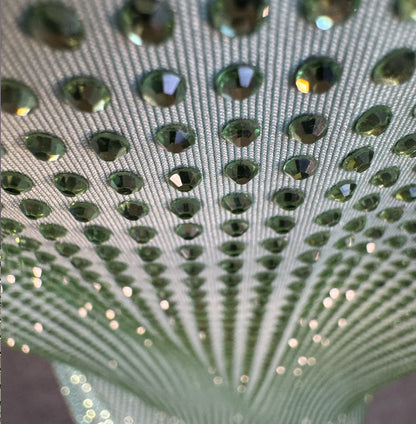 Looking down at Lt. Green Crystals on Lt. green Fabric T-shirt showing a close up of the rhinestone grid pattern and the sparkles as your focus shifts.