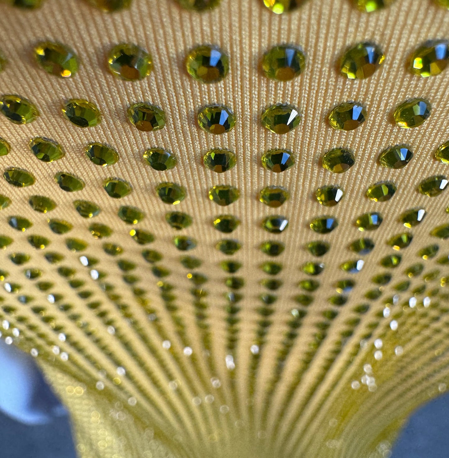 Looking down at Yellow Crystals on Yellow Fabric T-shirt showing a close up of the rhinestone grid pattern and the sparkles as your focus shifts.