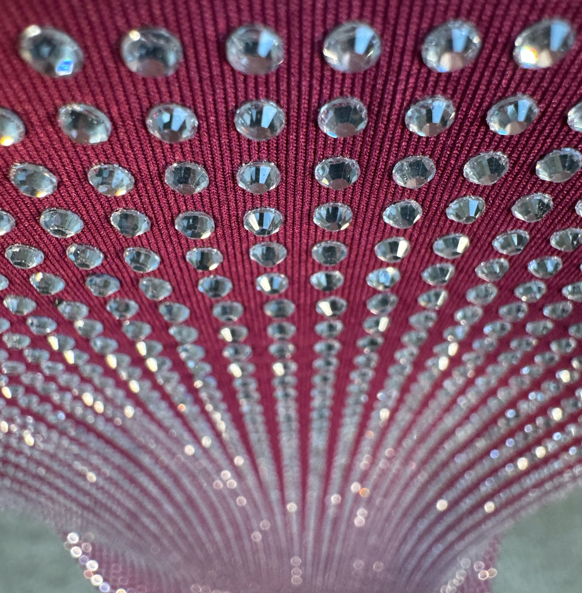 Looking down at Clear Crystals on Purple Fabric T-shirt showing a close up of the rhinestone grid pattern and the sparkles as your focus shifts.