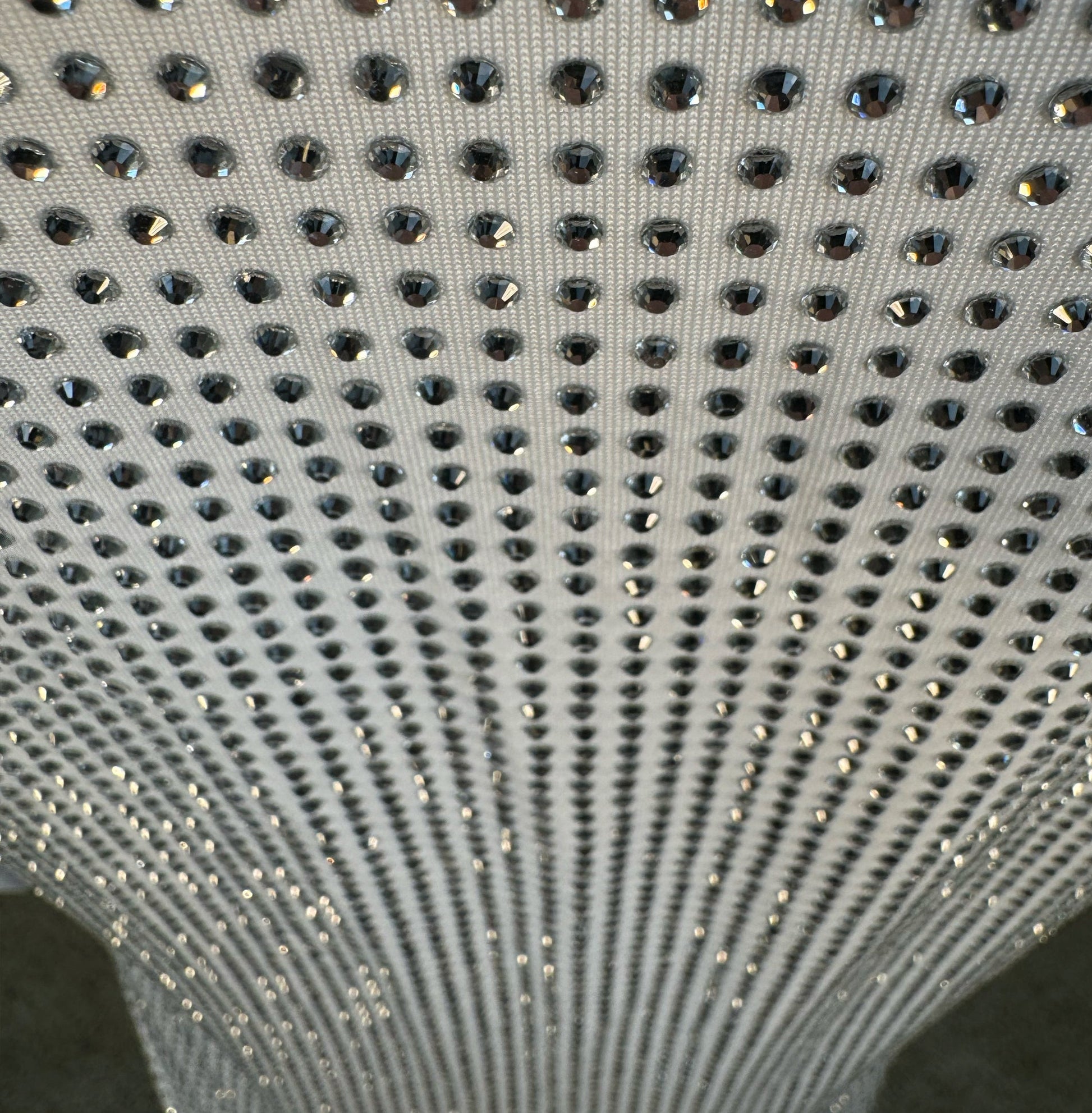 Looking down at Clear Crystals on White Fabric T-shirt showing a close up of the rhinestone grid pattern and the sparkles as your focus shifts.